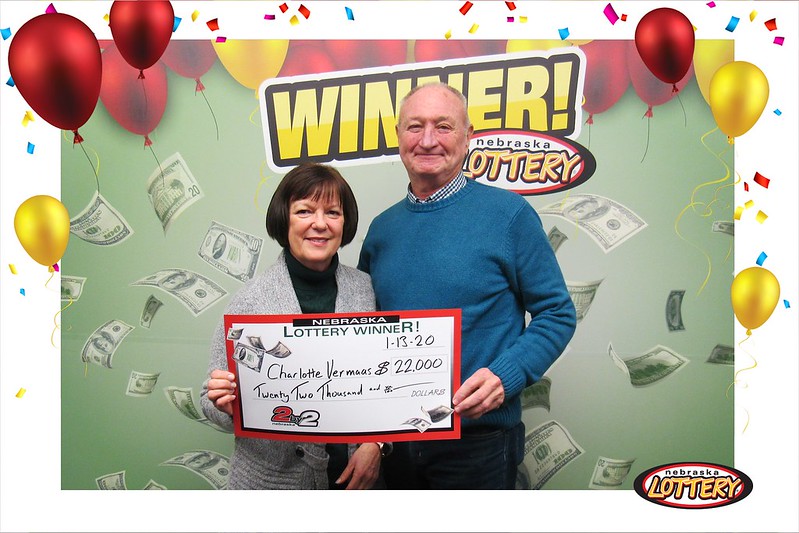 Charlotte and Lenny Vermaas of Gretna hold up a large check after winning $22,000 playing 2by2 from the Nebraska Lottery.